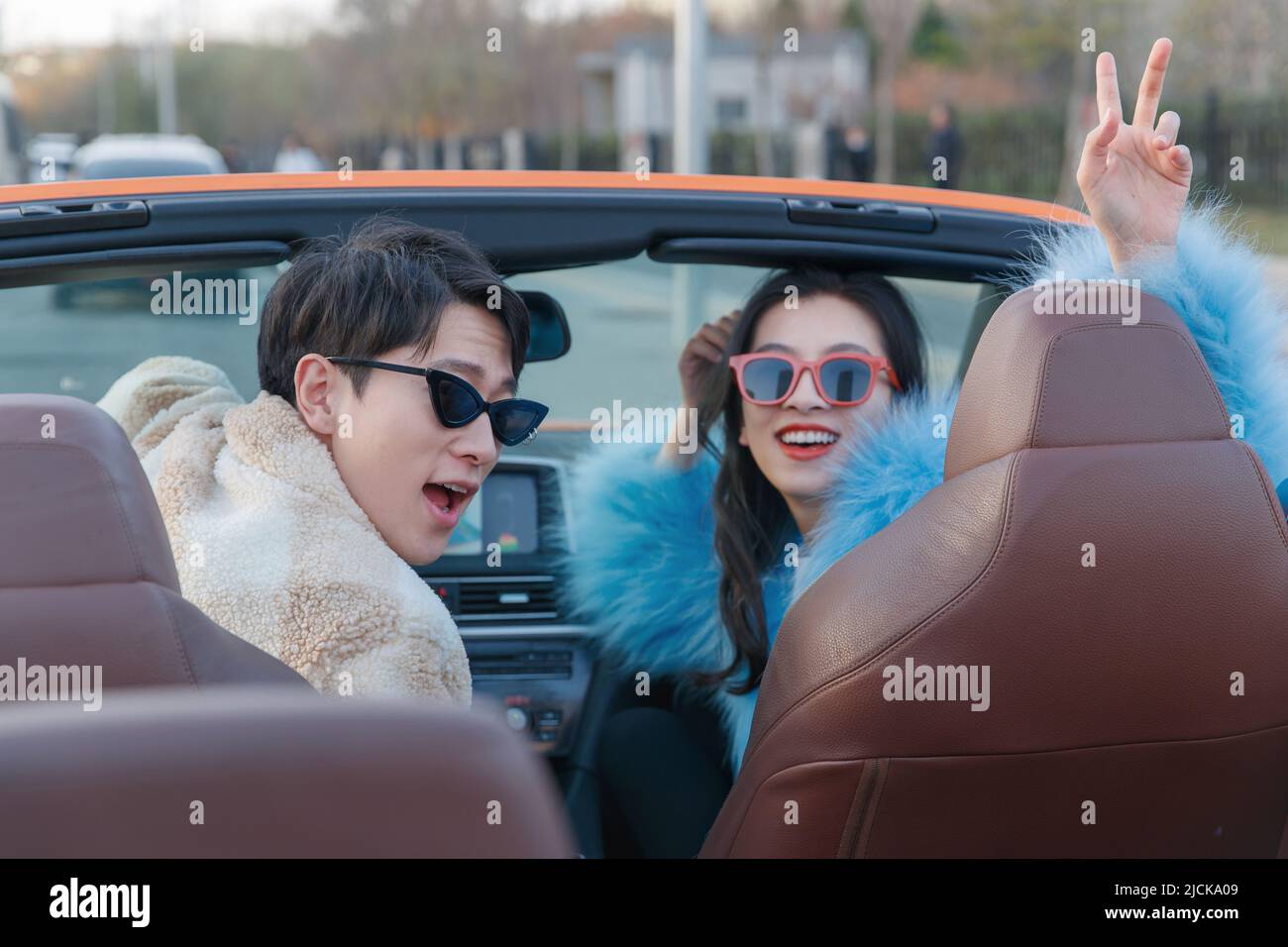 Fashionable young couples driving car for a ride Stock Photo