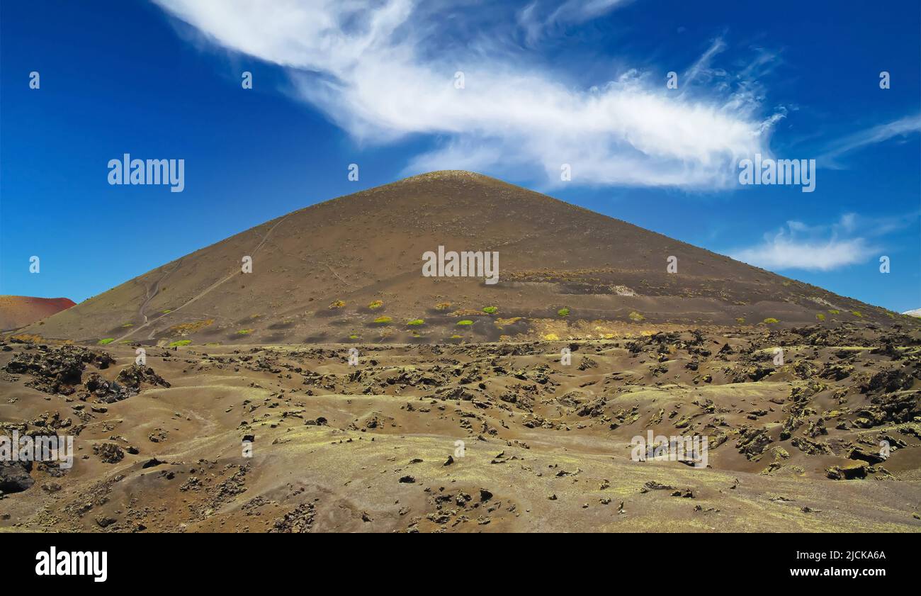 Monotone vulcanic landscape, lava ash sand field, volcano cone, clear blue sky - Timanfaya NP, Lanzarote Stock Photo