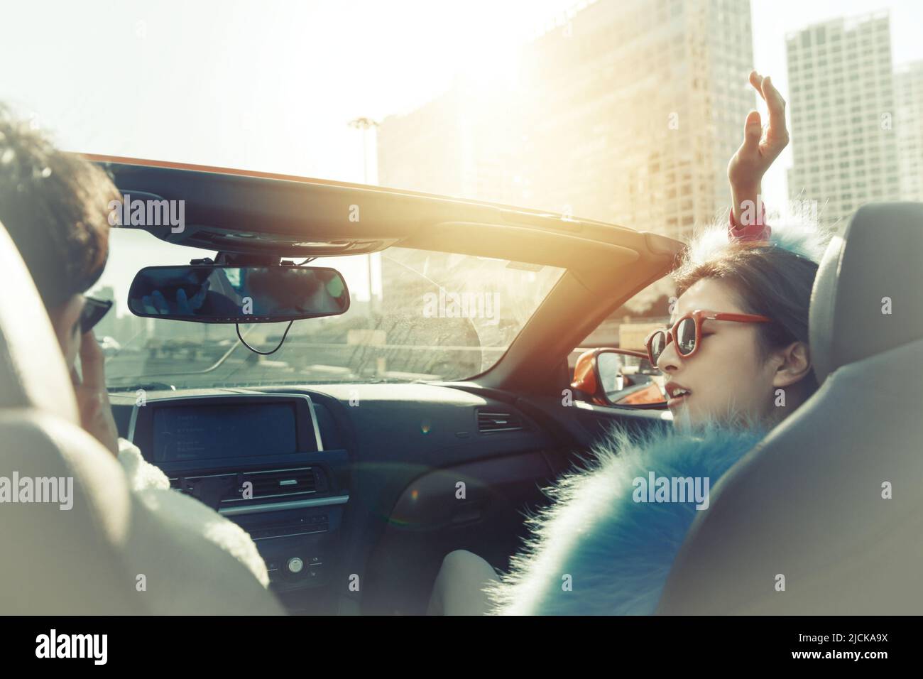 Fashionable young couples driving car for a ride Stock Photo - Alamy