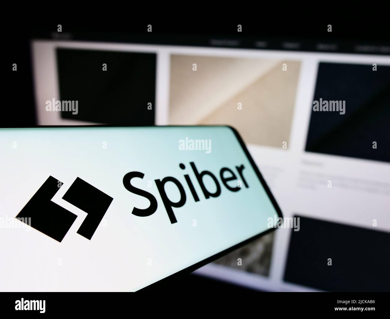 Cellphone with logo of Japanese biotechnology company Spiber Inc. on screen in front of business website. Focus on left of phone display. Stock Photo