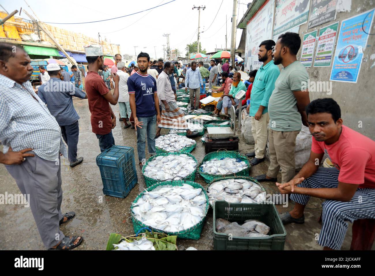 Buyers and sellers are seen at the wholesale fish market at Fishery