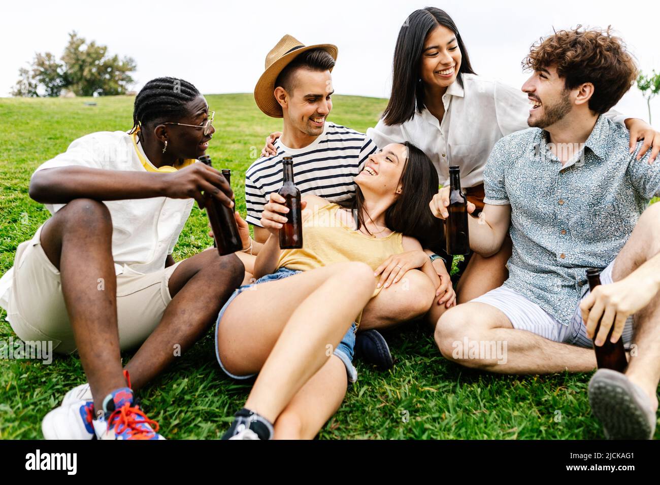 United group of millennial best friends hanging out relaxing on city park Stock Photo