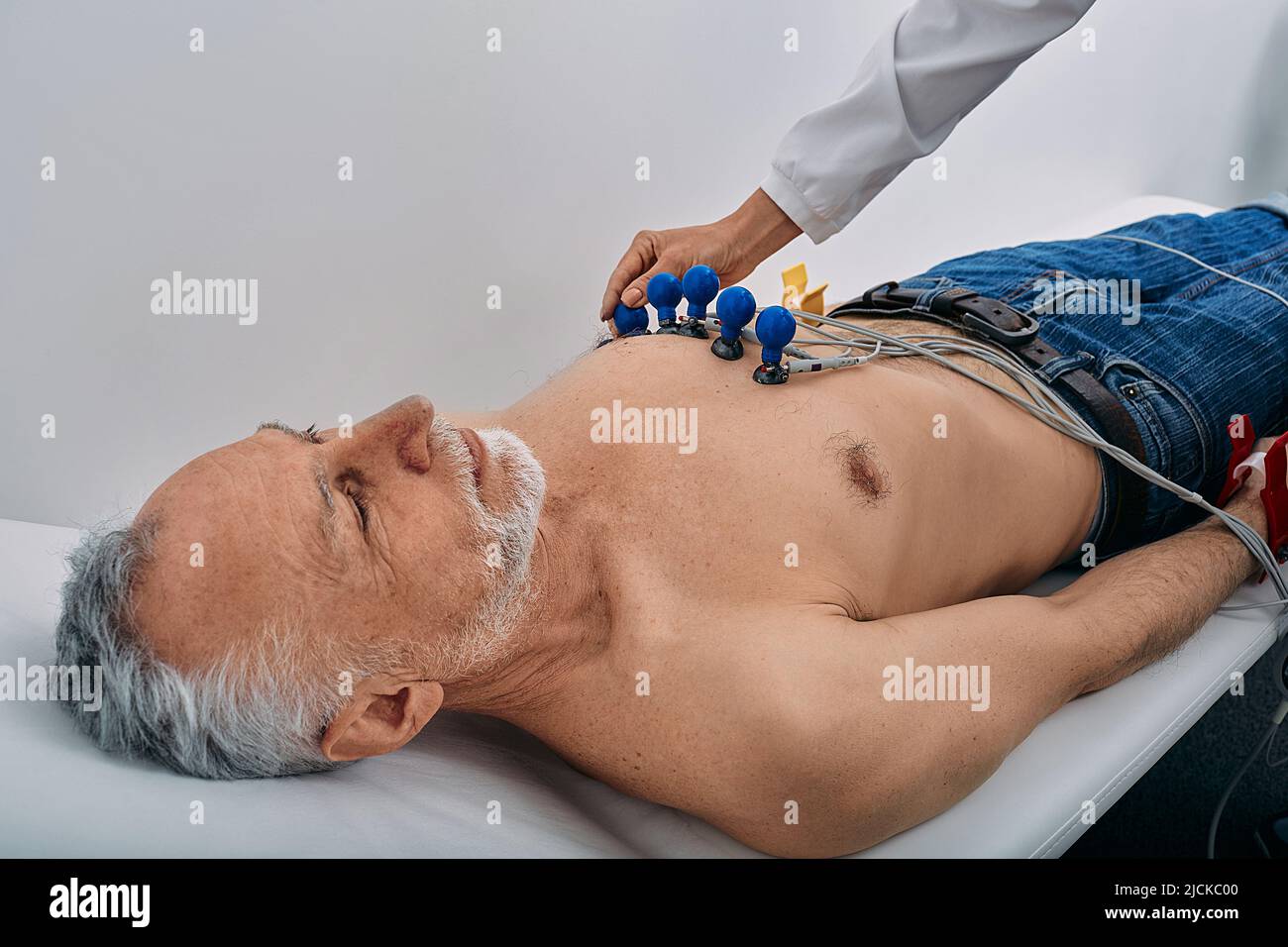 ECG procedure for male patient with electrodes for heart health exam in hospital. Electrocardiogram, cardiology Stock Photo