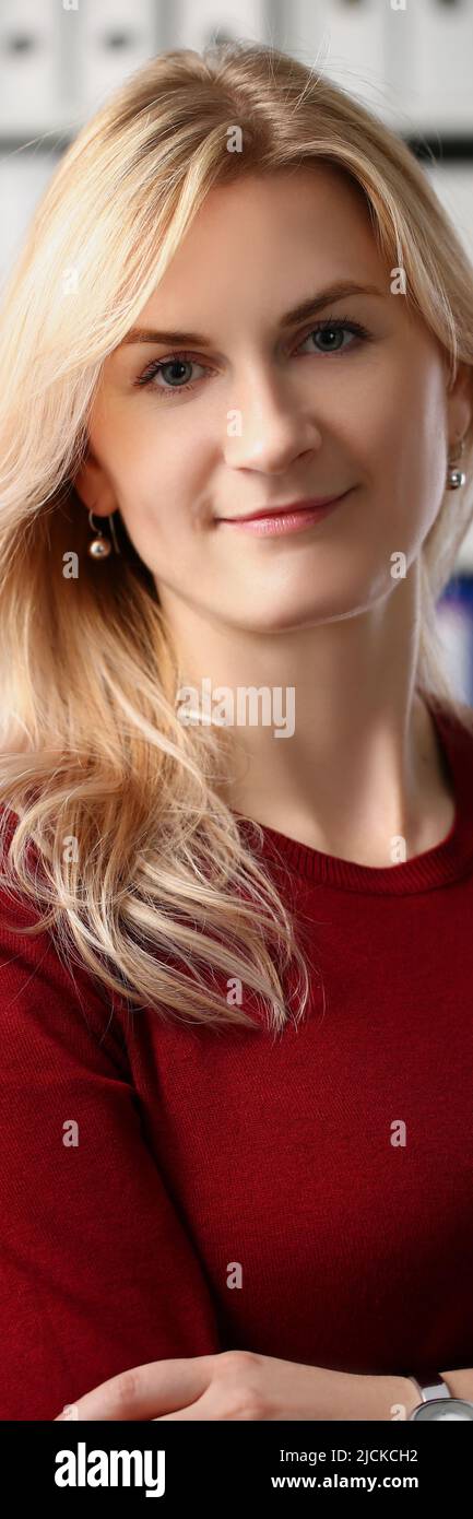 Presentable office worker smiling and posing for picture with crossed arms Stock Photo