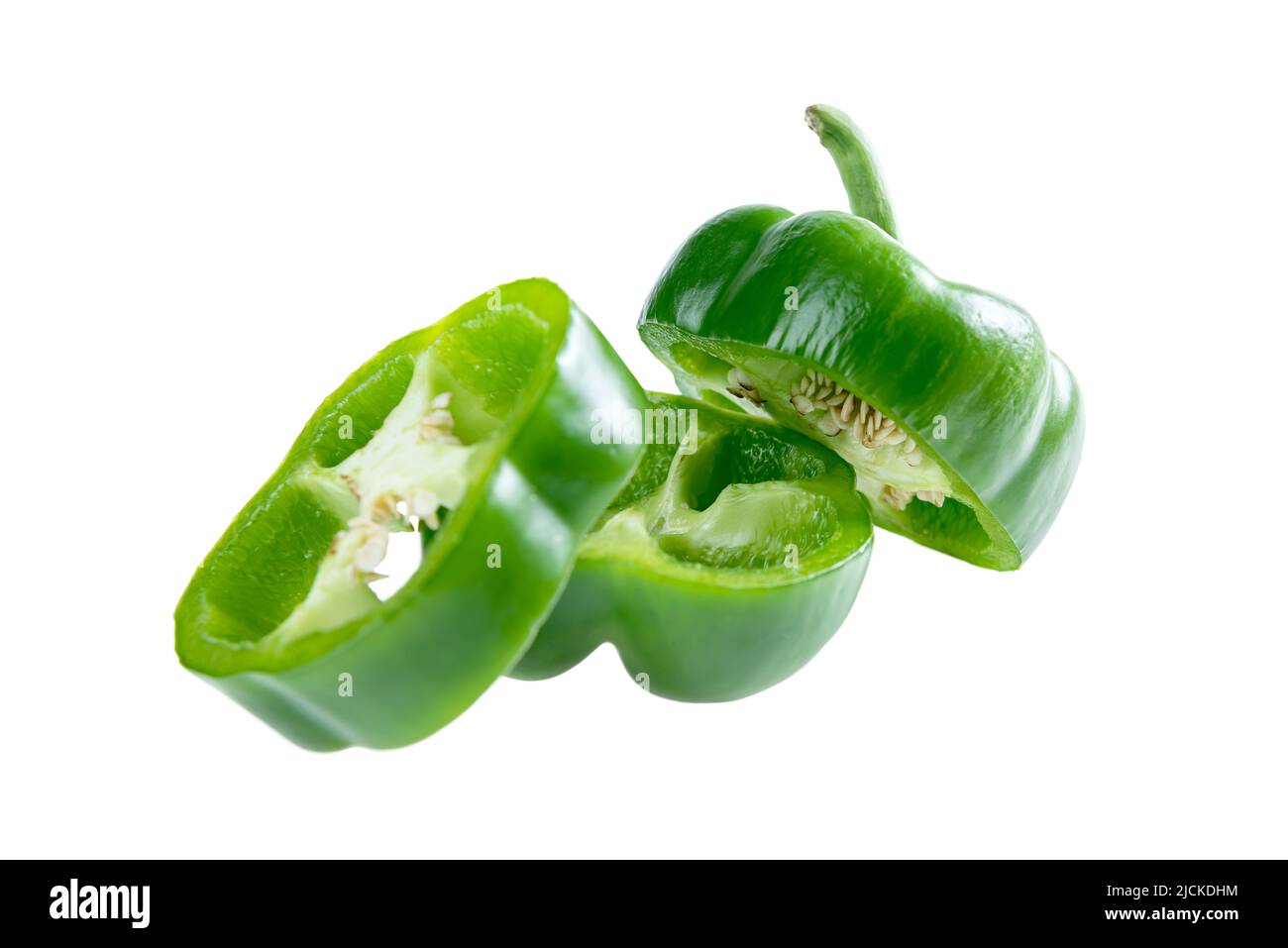 Sliced green peppers isolated over white background Stock Photo - Alamy