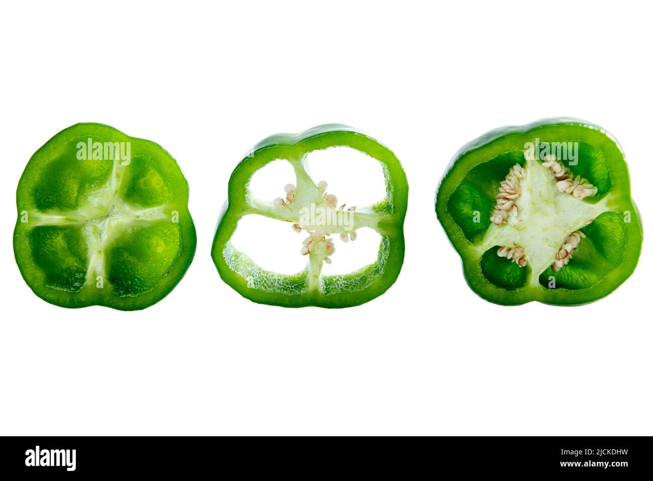Sliced green peppers isolated over white background Stock Photo - Alamy