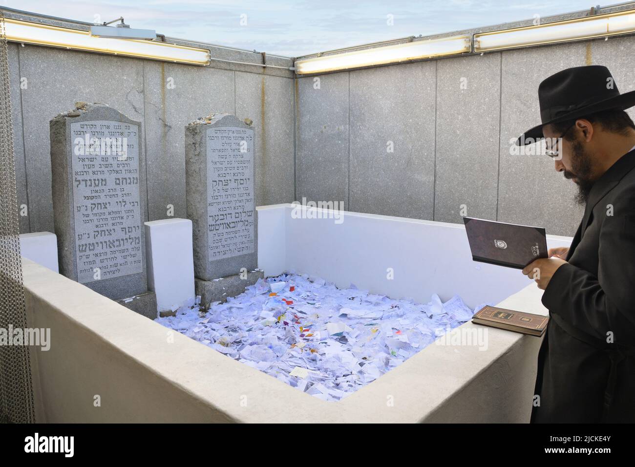 An orthodox jewish man prays at the Ohel at the headstones of the sixth ...