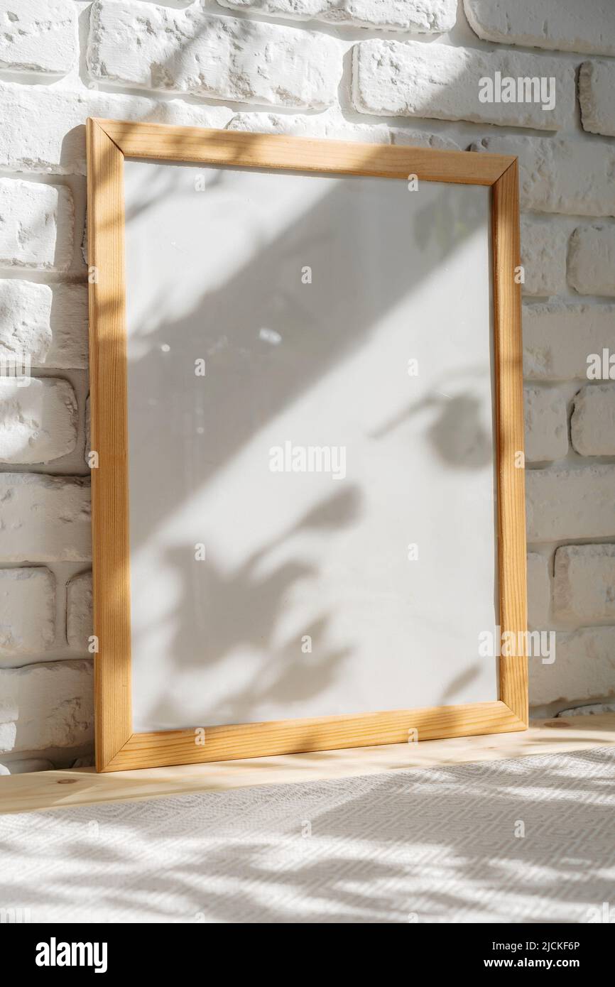 Photo frames on floor over white brick wall Stock Photo
