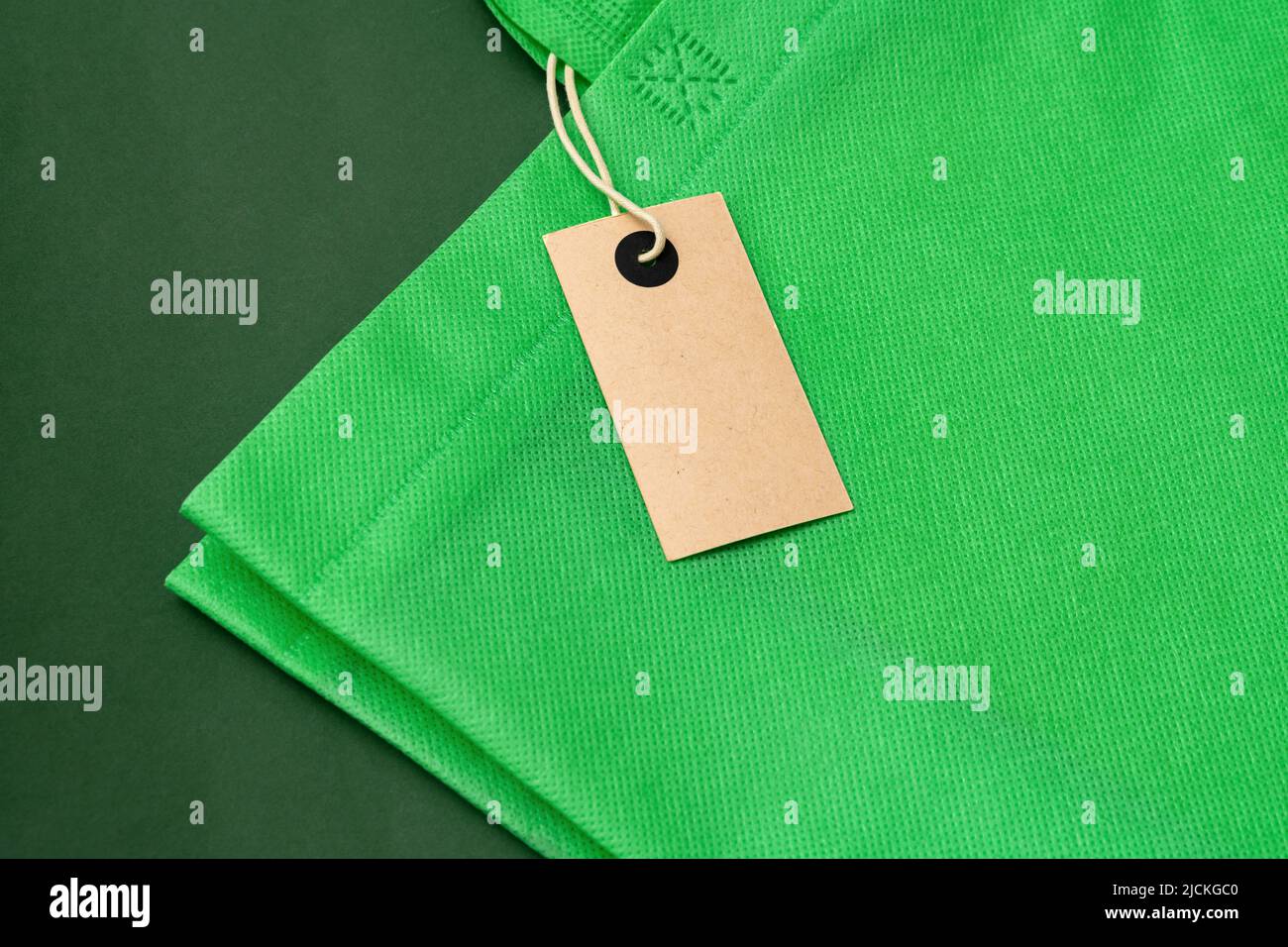 Textile shopping bag on green background flat lay Stock Photo - Alamy