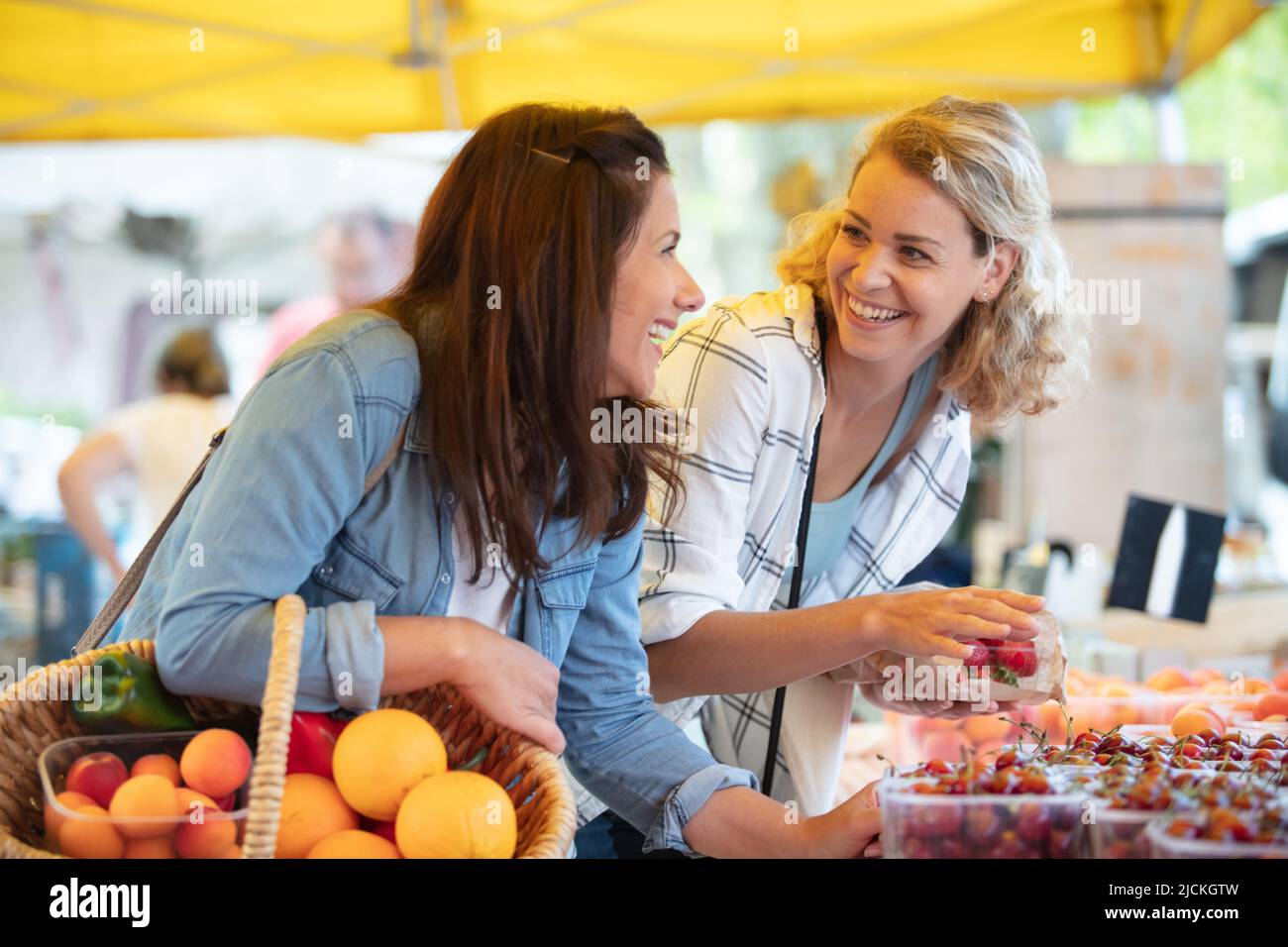 women choose fruits and vegetables at a food market Stock Photo Alamy
