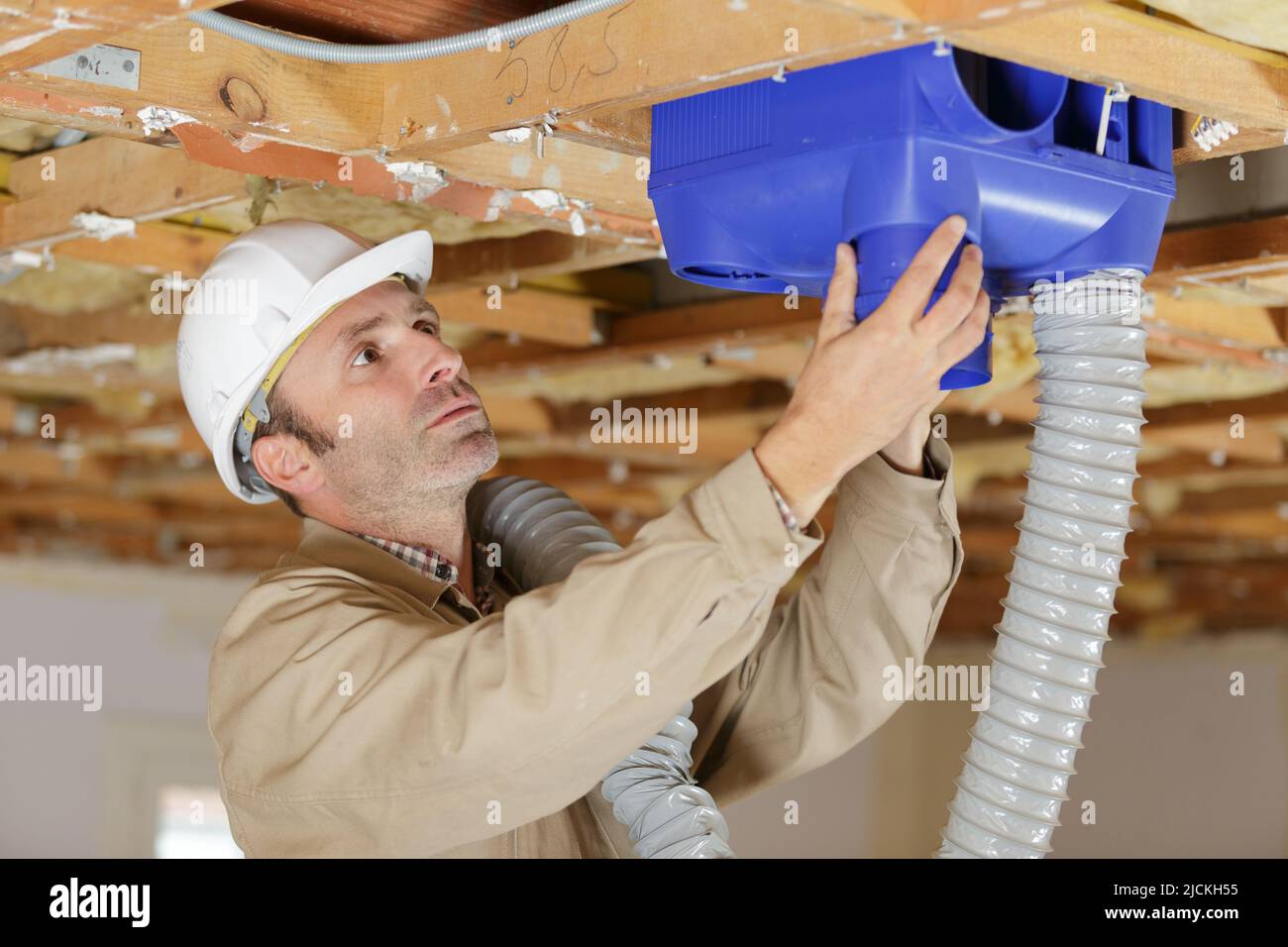 builders working on house ventilation pipes Stock Photo Alamy