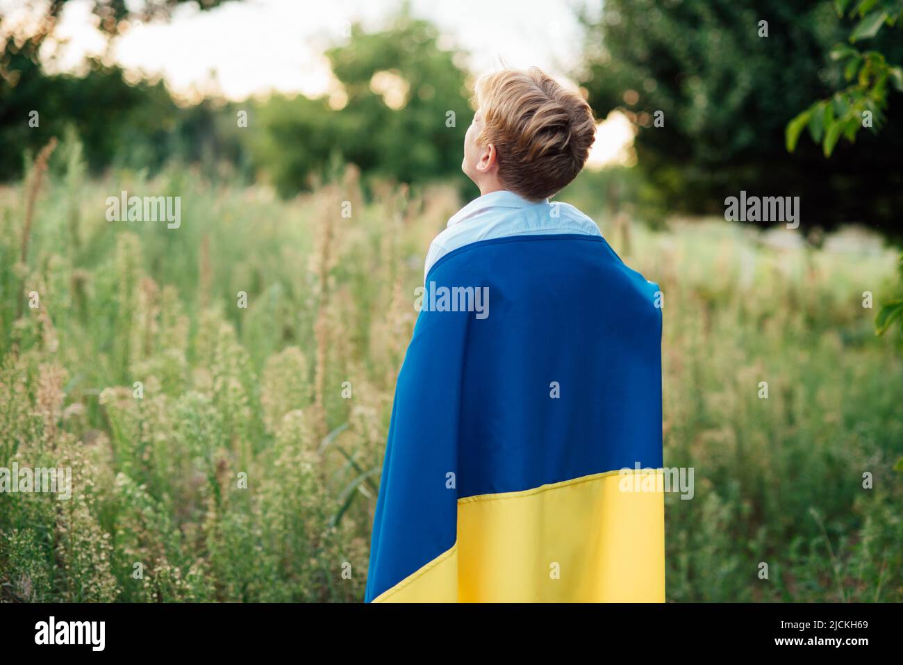 Ukraines Independence Flag Day. Constitution day. Ukrainian child boy in shirt with yellow and blue flag of Ukraine in field. flag symbols of Ukraine. Kyiv, Kiev day Stock Photo