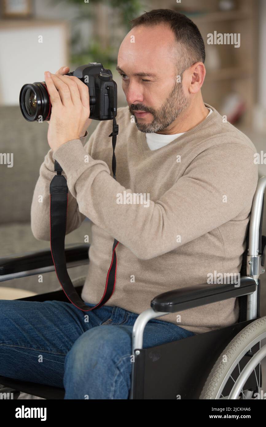 male photographer on wheelchair checking camera Stock Photo