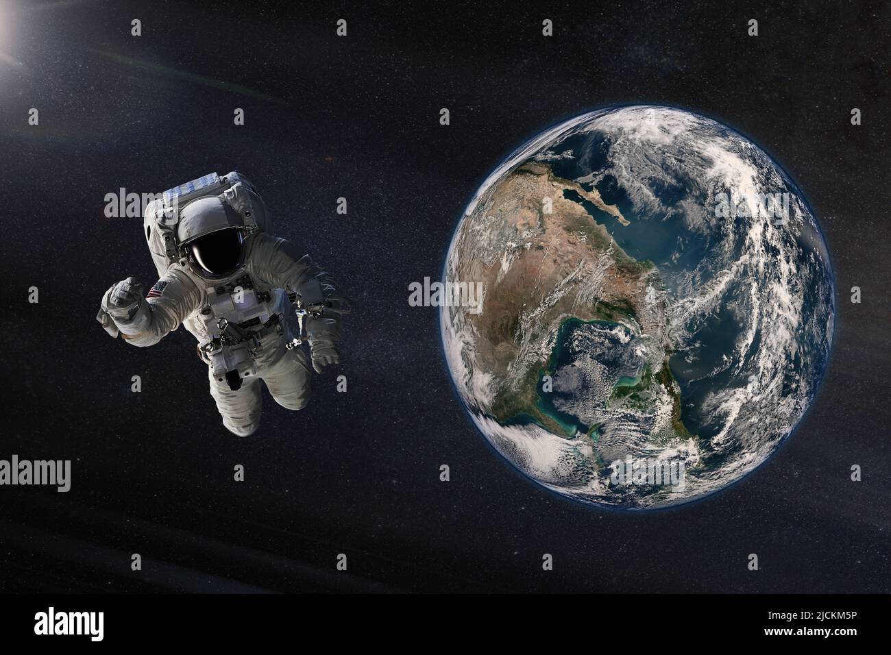 Spaceman in outer space with Earth planet. Elements of this image furnished by NASA. Stock Photo