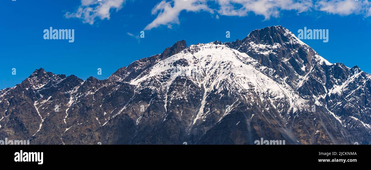 panorama of beautiful and snowy Caucasus mountains in the sunny weather, Kazbegi, Georgia. High quality photo Stock Photo