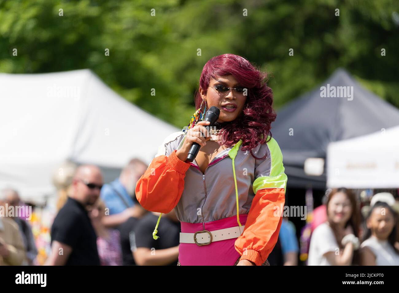 A female (lady boy) singer and walking amongst the crowd at the Magic of Thailand Festival at Basingstoke War Memorial Park. June 12th 2022. England Stock Photo