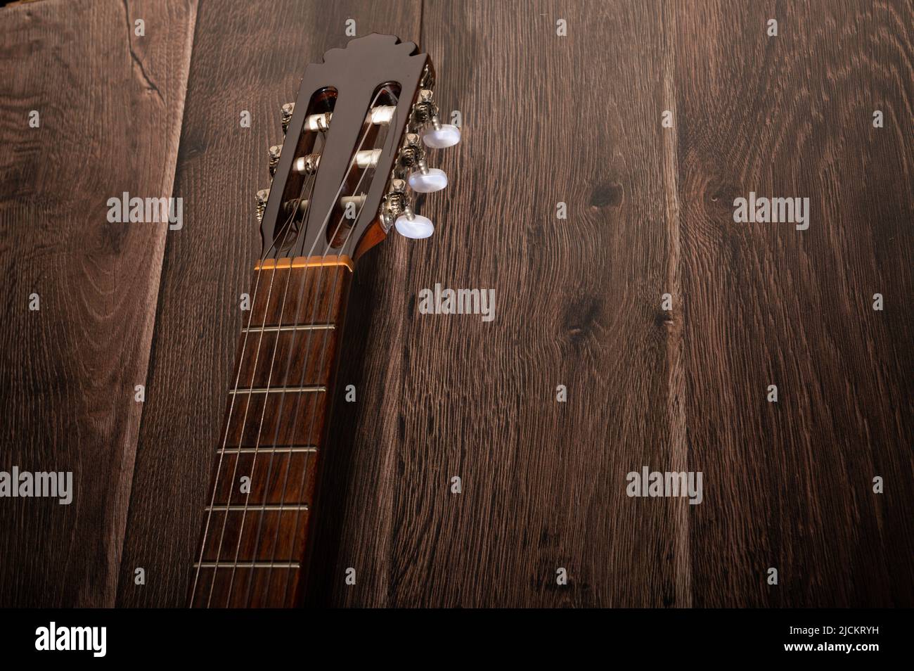 Classical guitar fretboard and machine on a dark wood background with copy space Stock Photo Alamy