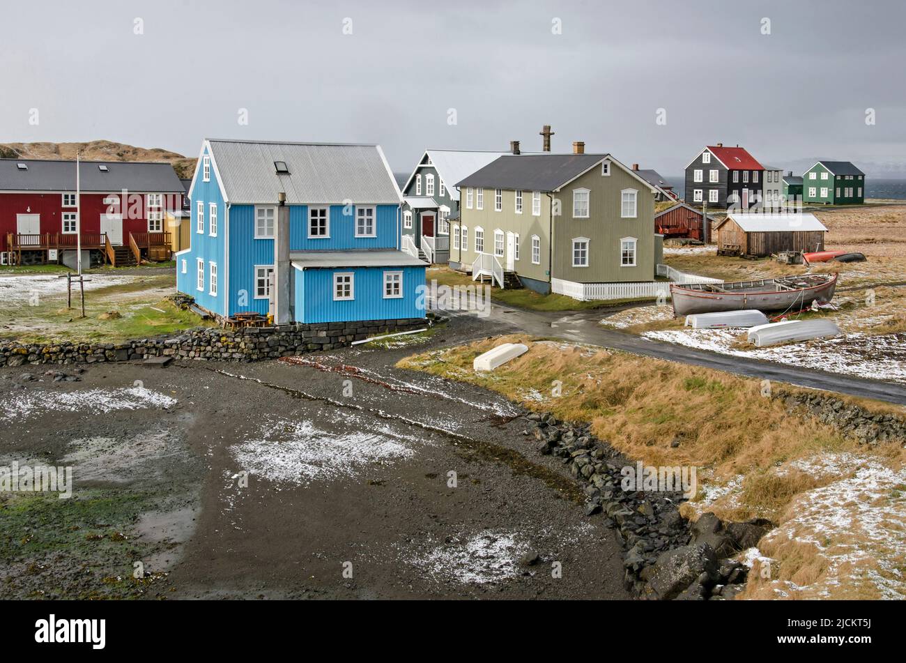 Flatey, Iceland, May 5, 2022: colorful houses of wood and corrugated metal in the island's village by the bay Stock Photo