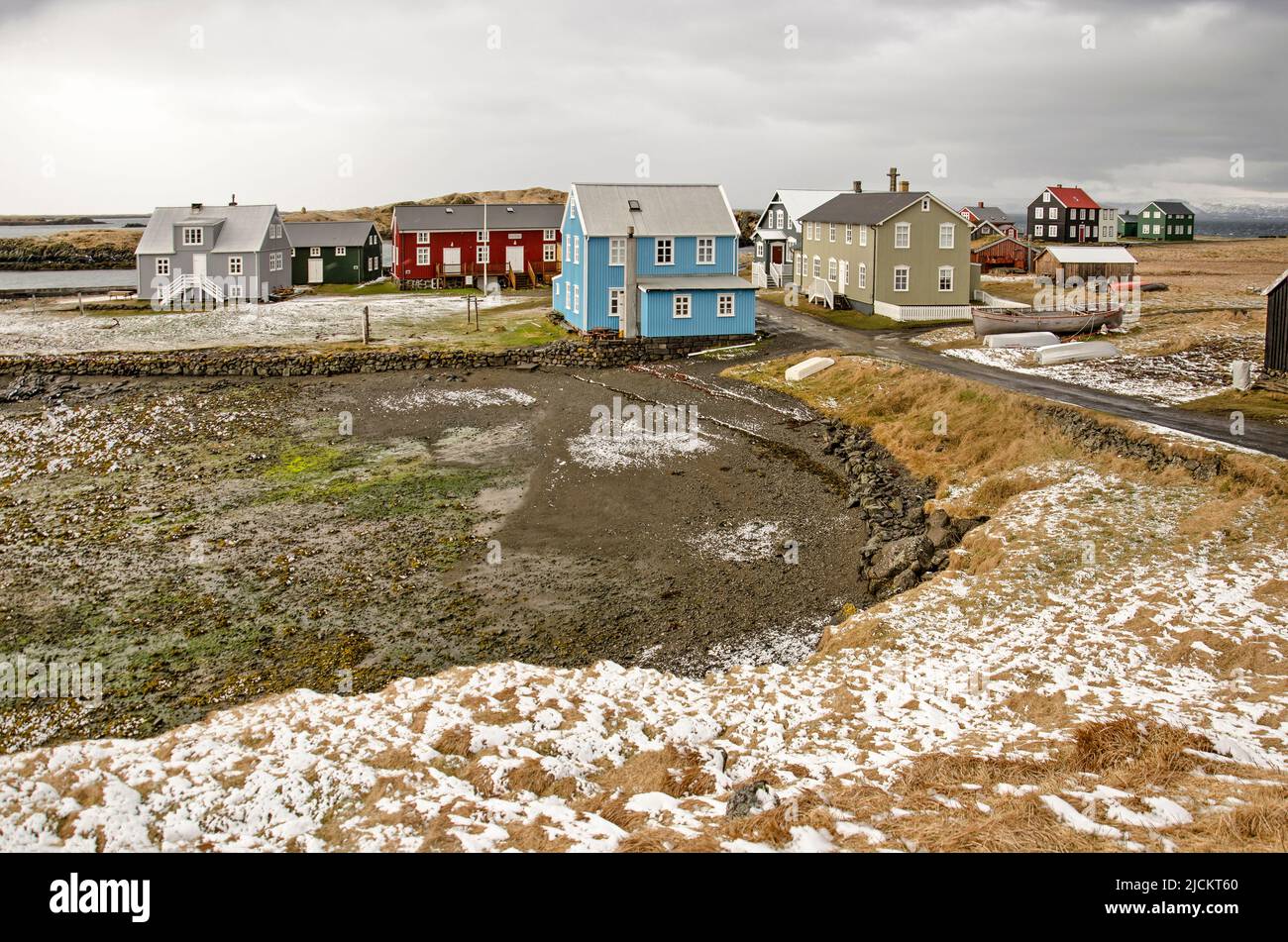 Flatey, Iceland, May 5, 2022: view across a tiny bay towards the village with its colorful houses Stock Photo