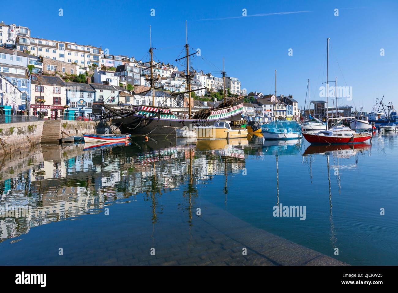 UK, England, Devon, Torbay, Brixham Harbour and The Quay with moored Boats and The Golden Hind (museum ship) Stock Photo