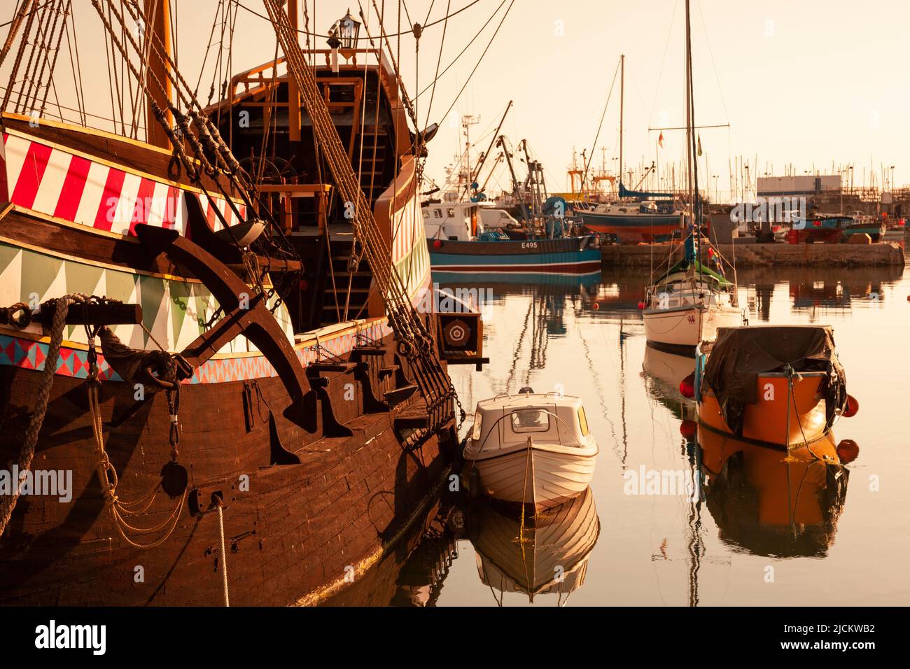 UK, England, Devon, Torbay, Brixham Harbour, Full size replica of the famous Golden Hind galleon with moored Boats at Dawn Stock Photo