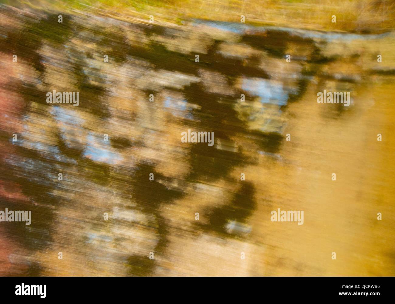 abstract design background backdrop of beige black and blue soft focus motion blur created by long time exposure and intentional camera movement Stock Photo