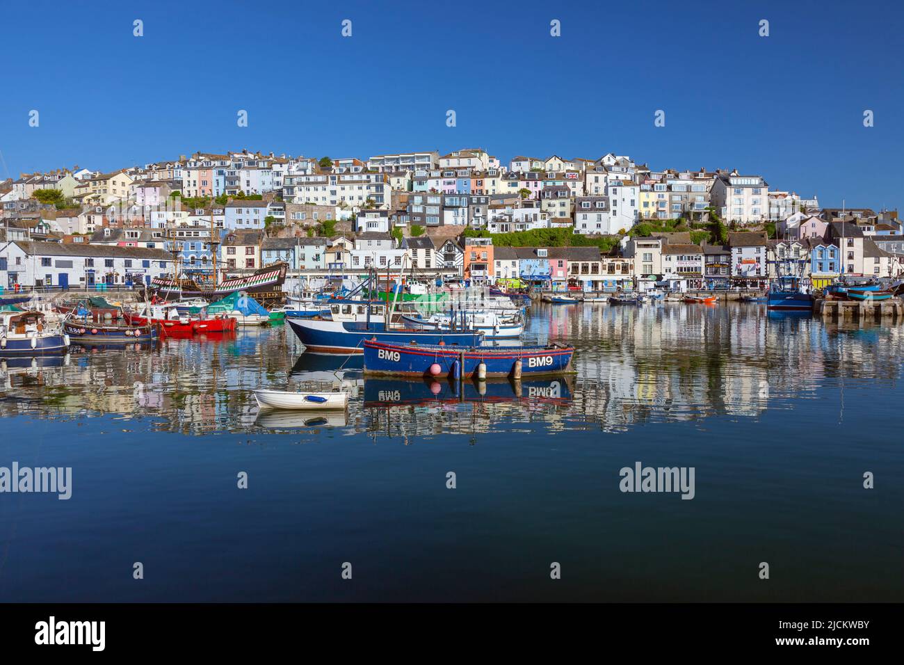 UK, England, Devon, Torbay, Brixham Harbour and The Quay with moored Boats and The Golden Hind (museum ship) Stock Photo