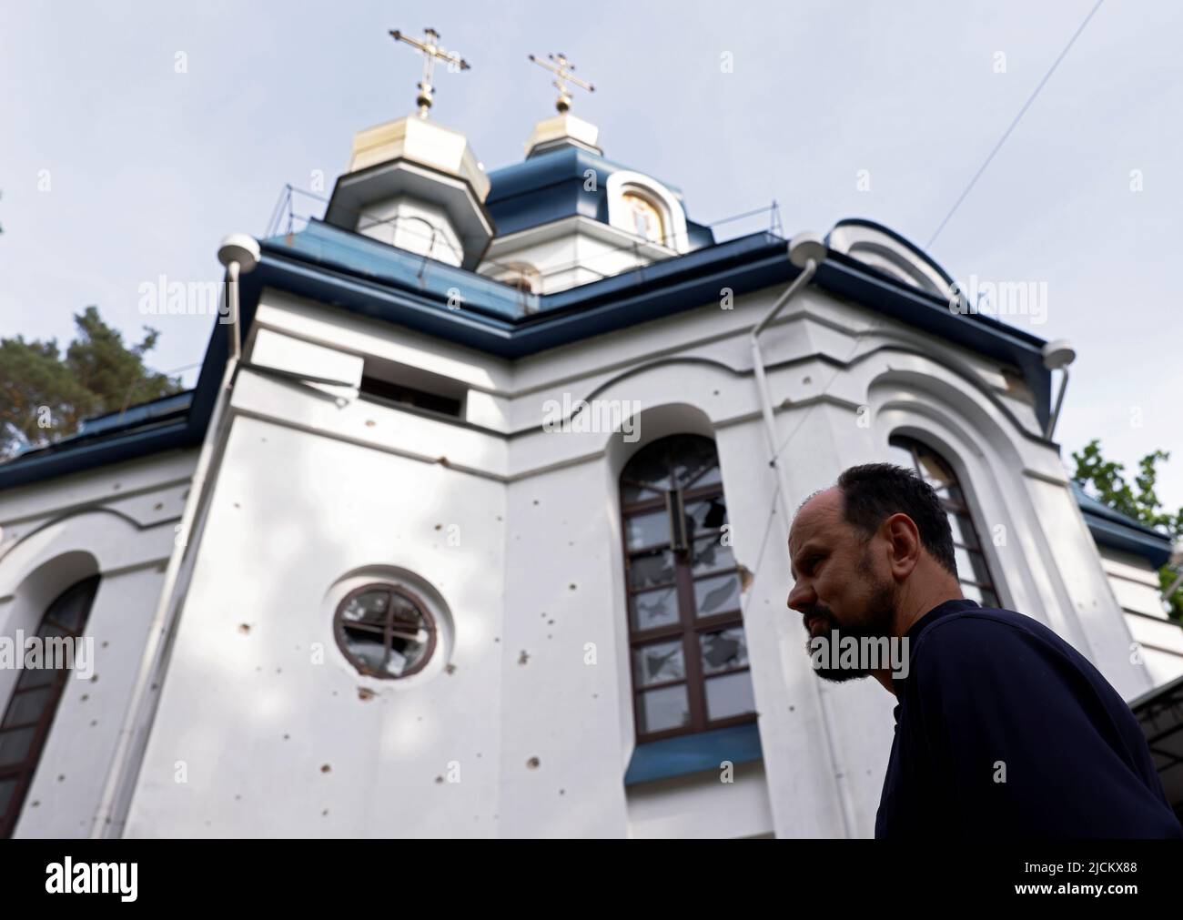 Parish priest Andriy Klyushev talks about the damage from bullets and shrapnel to his church, as Russia's attack on Ukraine continues, in Irpin, Kyiv region, Ukraine June 4, 2022. Picture taken June 4, 2022.  REUTERS/Edgar Su Stock Photo