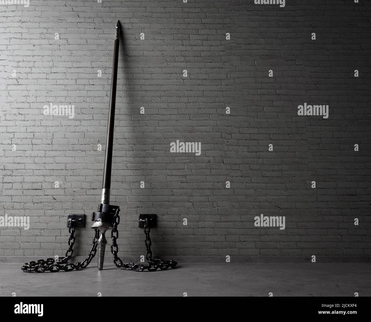 A play on words concept showing an upstanding medieval wooden lance shackled with iron shackles  to an isolated brick wall  - 3D render Stock Photo