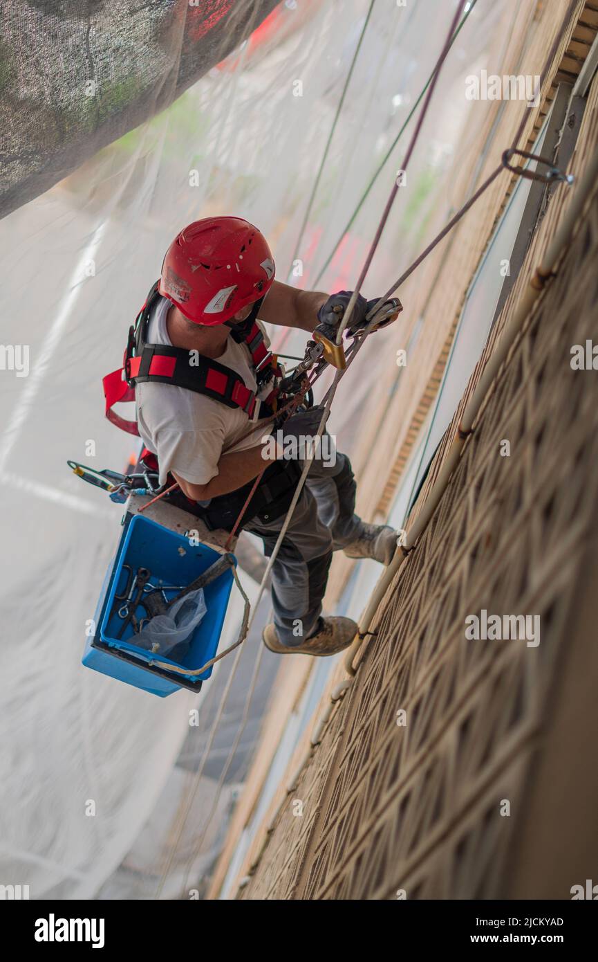 Industrial climbers at work in residential building Stock Photo