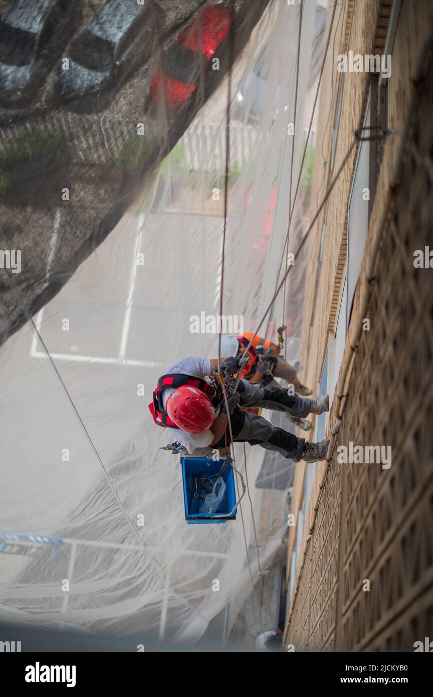 Industrial climbers at work in residential building Stock Photo