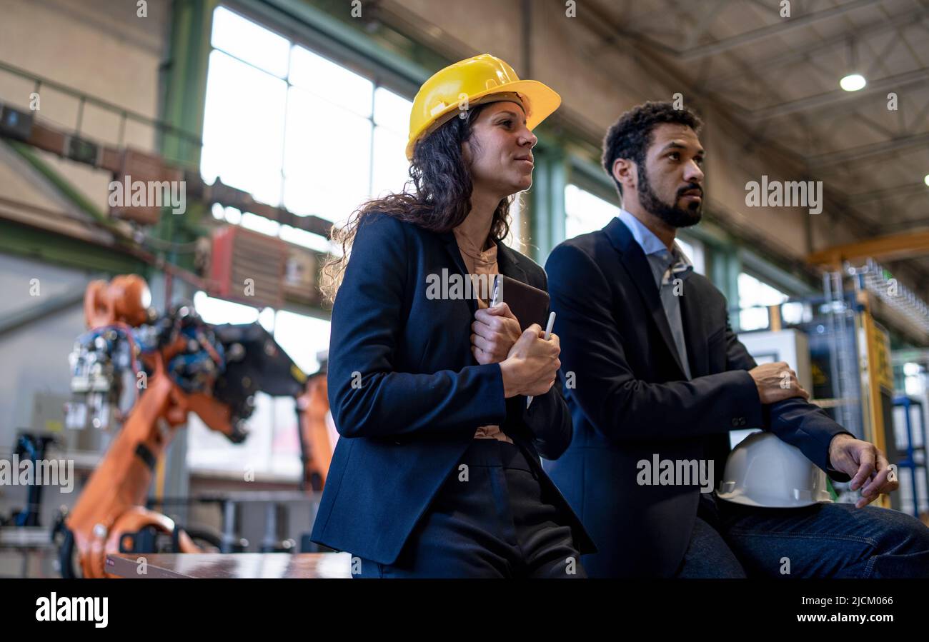 Chief engineer and project manager in modern industrial factory with