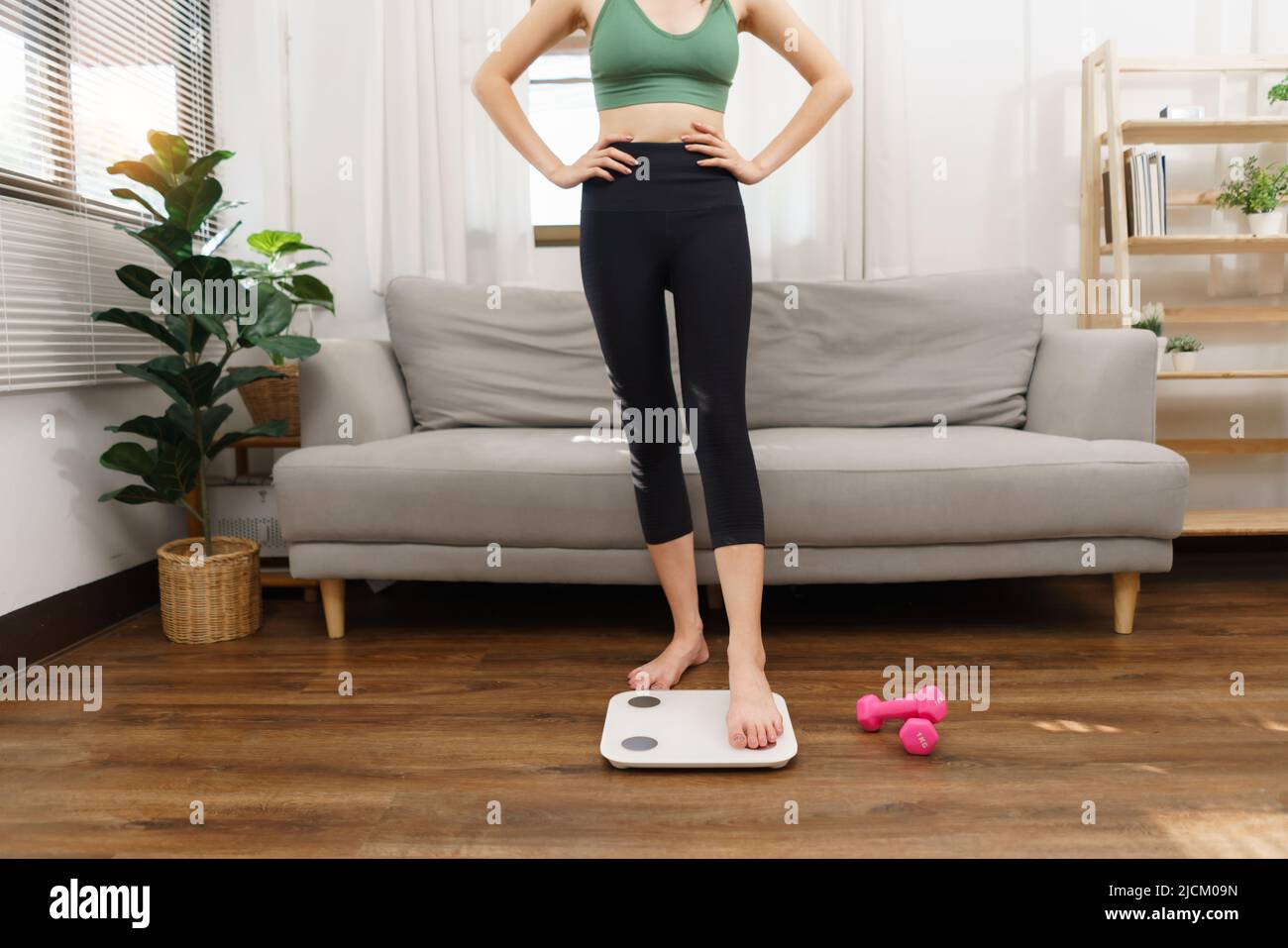 Healthy and weight loss concept, Young Asian woman stepping on weighing ...