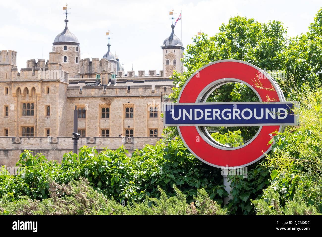 London underground sign at Tower Hill station with the Tower of London