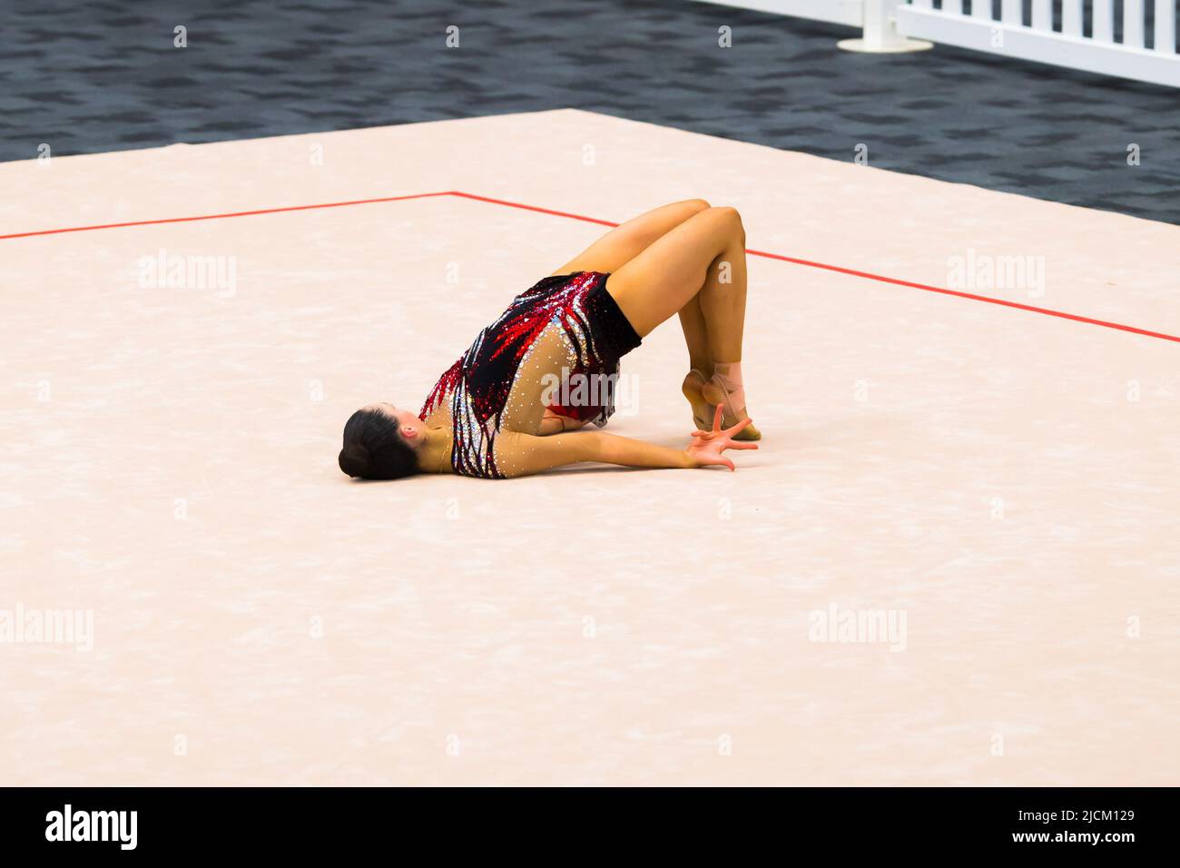 Australian Senior International Rhythmic Gymnast, Ashari Gill, starting  pose of a hoop routine during 2022 Oceania Rhythmic Gymnastics Continental  Championships. The event was running in parallel with Australian Gymnastics  Championships on Gold