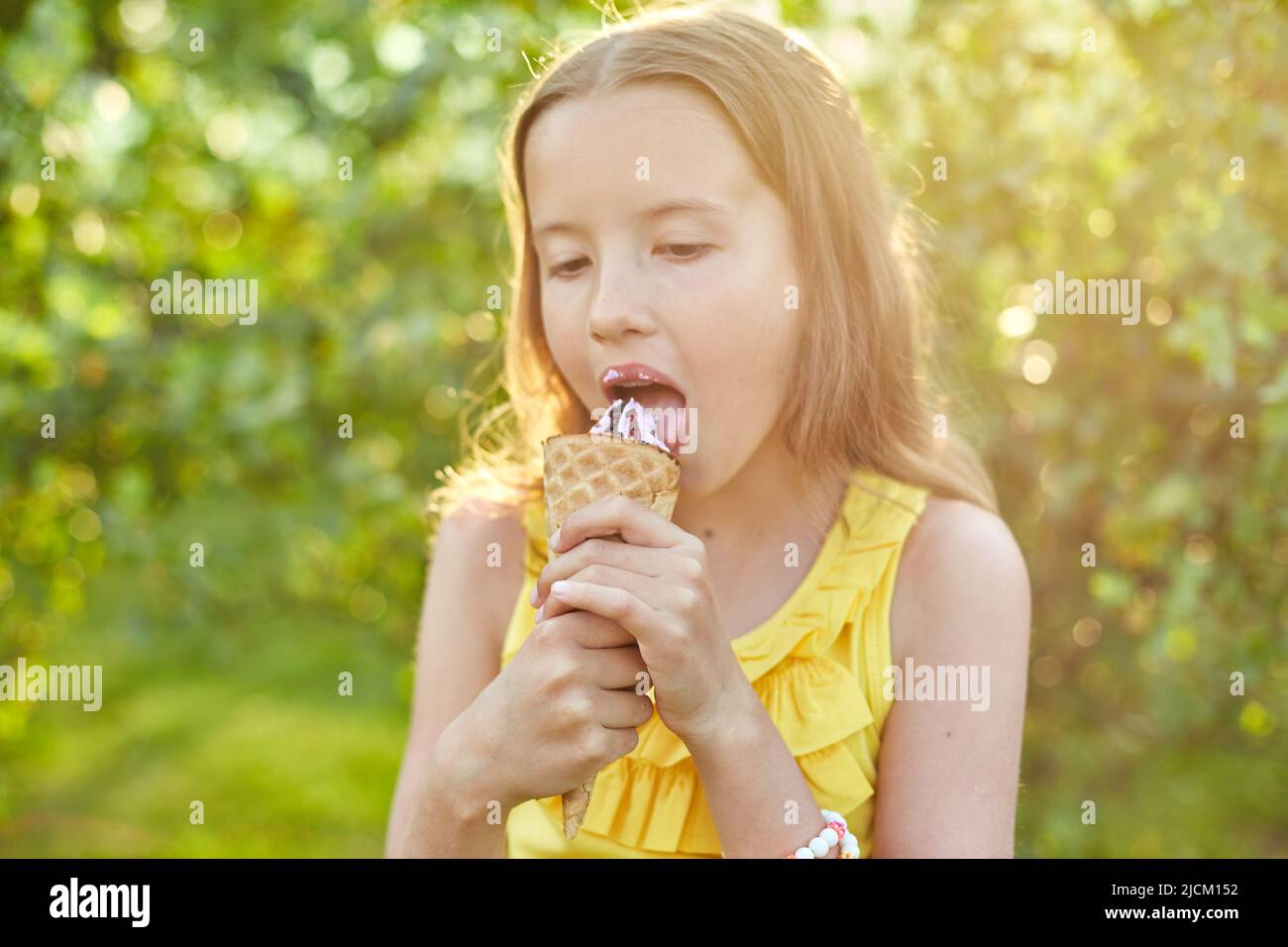 Happy girl with braces eating italian ice cream cone smiling while
