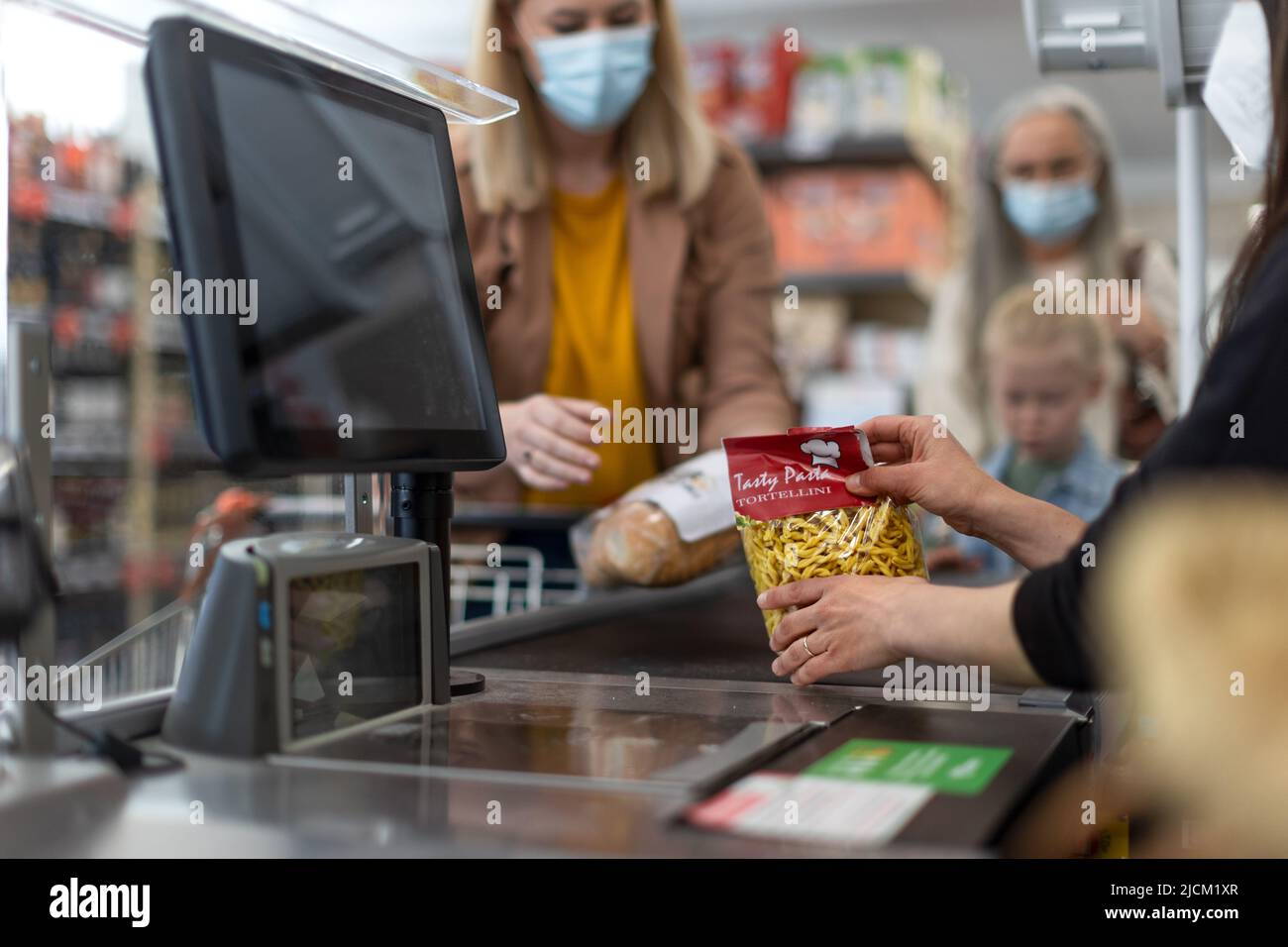 Checkout counter hands of the cashier scans groceries in supermarket. Stock Photo