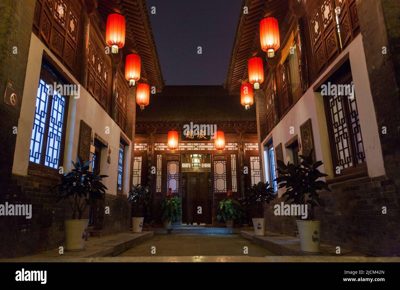 Outside exterior view of enclosed courtyard at night; evening view of gardens at Gao 's Grand Courtyard / Gao Family Mansion; traditional ancient styled folk house at No144 of Bei Yuan Men. Former villa residence of Gao Yue Song; located at No 144 of Bei Yuan Men, in Xi'an. PRC. China. (125) Stock Photo