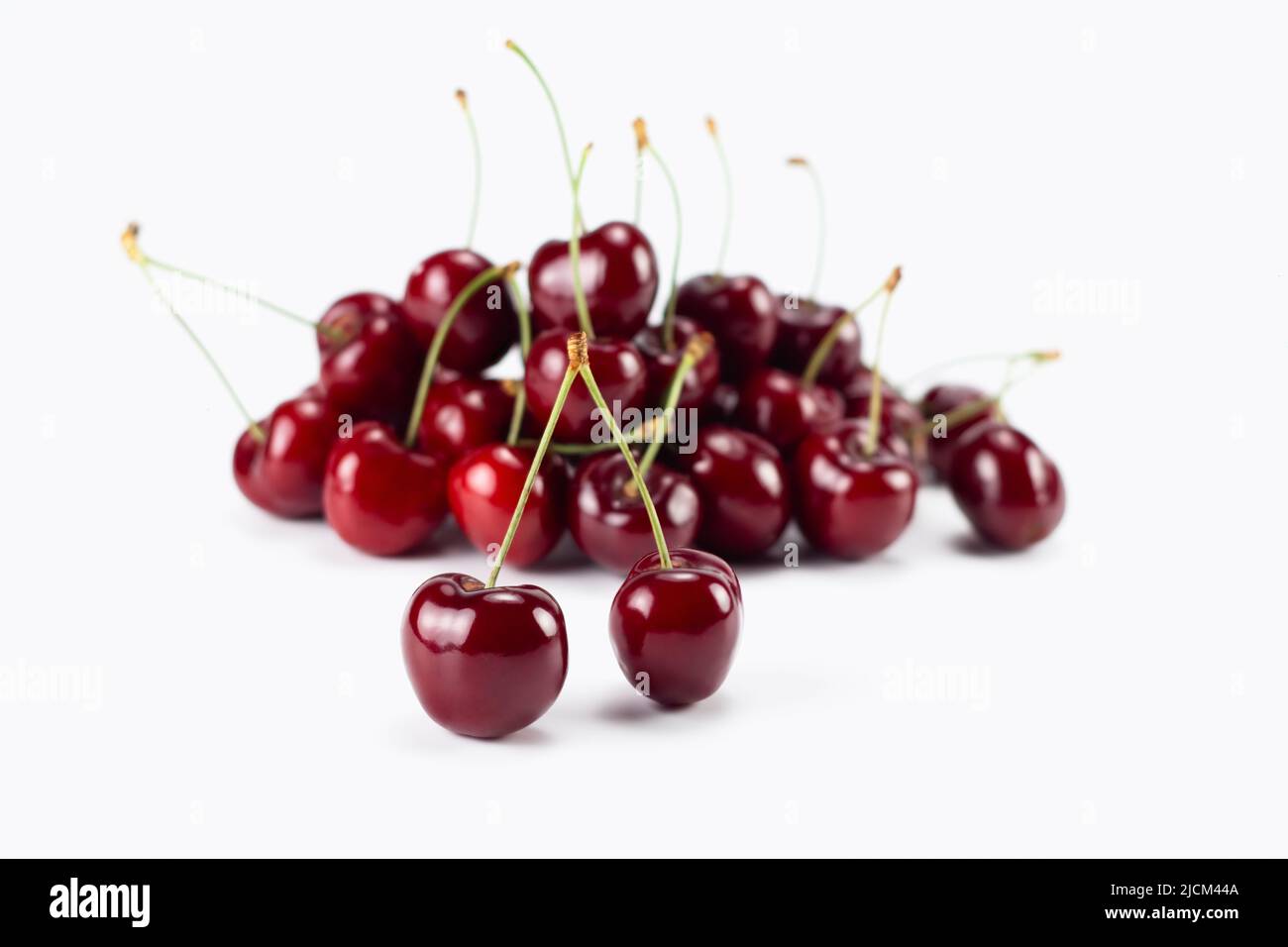 Fresh cherry fruit isolated on bright background. Selective focus. Stock Photo