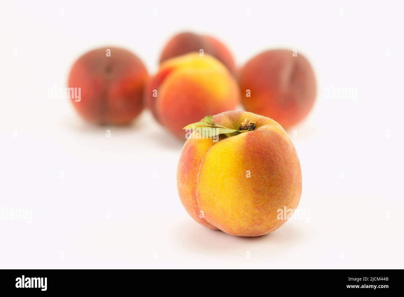 Fresh peaches on bright background. Selective focus. Stock Photo