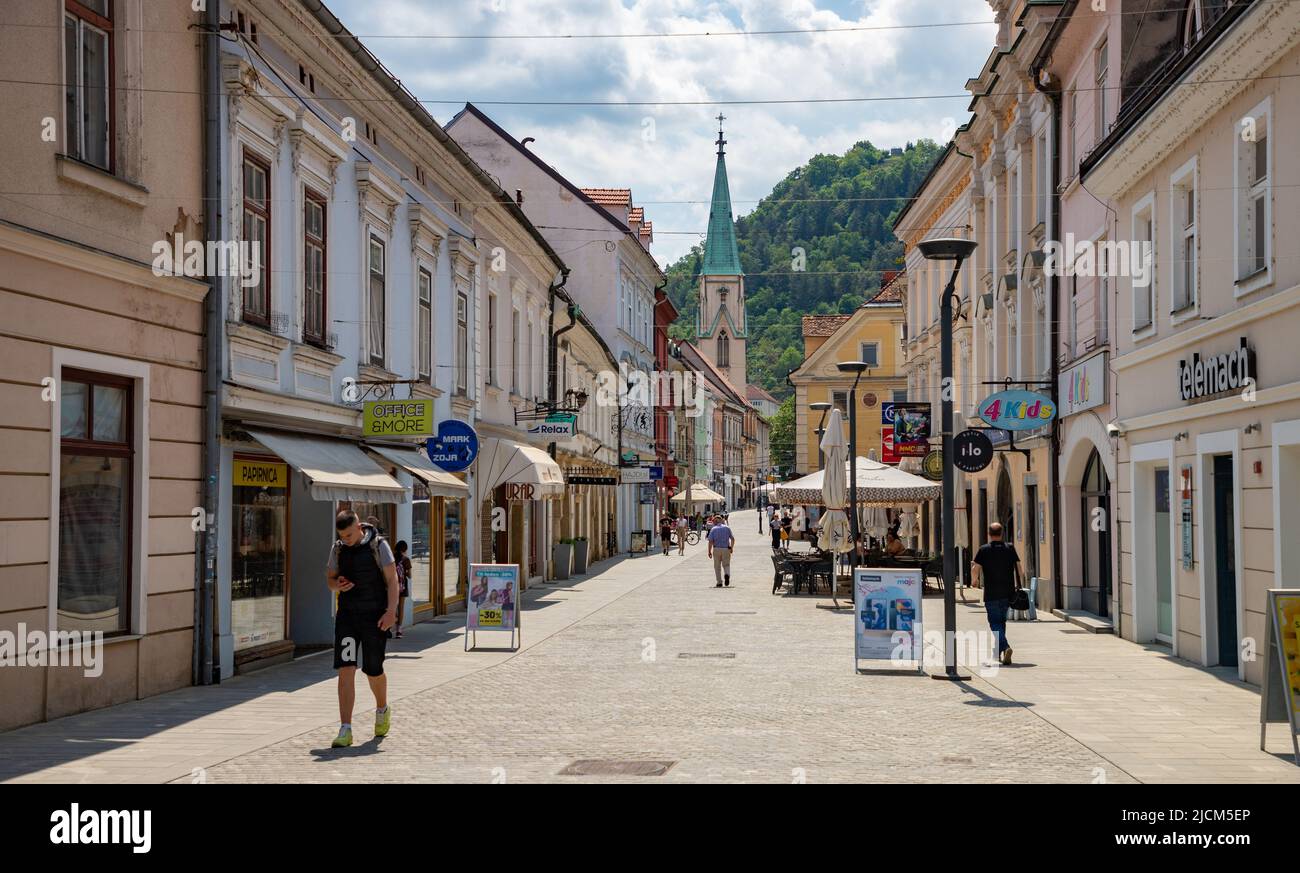 A picture of the busy Stanetova Street in Celje, with the tower of the Celje Cathedral in the distance. Stock Photo