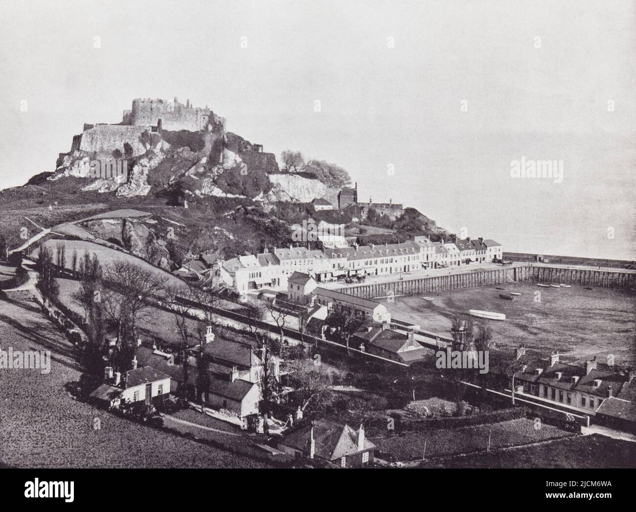 Saint Martin, Jersey, Channel Isalnds, English Channel.  Gorey and Mont Orgueil Castle seen here in the 19th century.  From Around The Coast,  An Album of Pictures from Photographs of the Chief Seaside Places of Interest in Great Britain and Ireland published London, 1895, by George Newnes Limited. Stock Photo