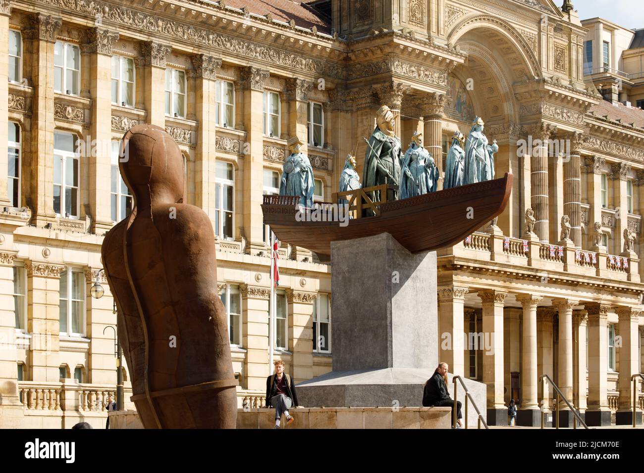 A major public artwork in which acclaimed Guyanese-British artist Hew Locke reimagines Birmingham’s city-centre sculpture of Queen Victoria. The project has been commissioned by Ikon Gallery for the Birmingham 2022 Festival (the cultural programme of the Commonwealth Games).  Titled Foreign Exchange, the spectacular work will be Locke’s first temporary public sculpture. Pictured, Anthony Gormley's Iron Man statue looks across at Foreign Exchange. Stock Photo