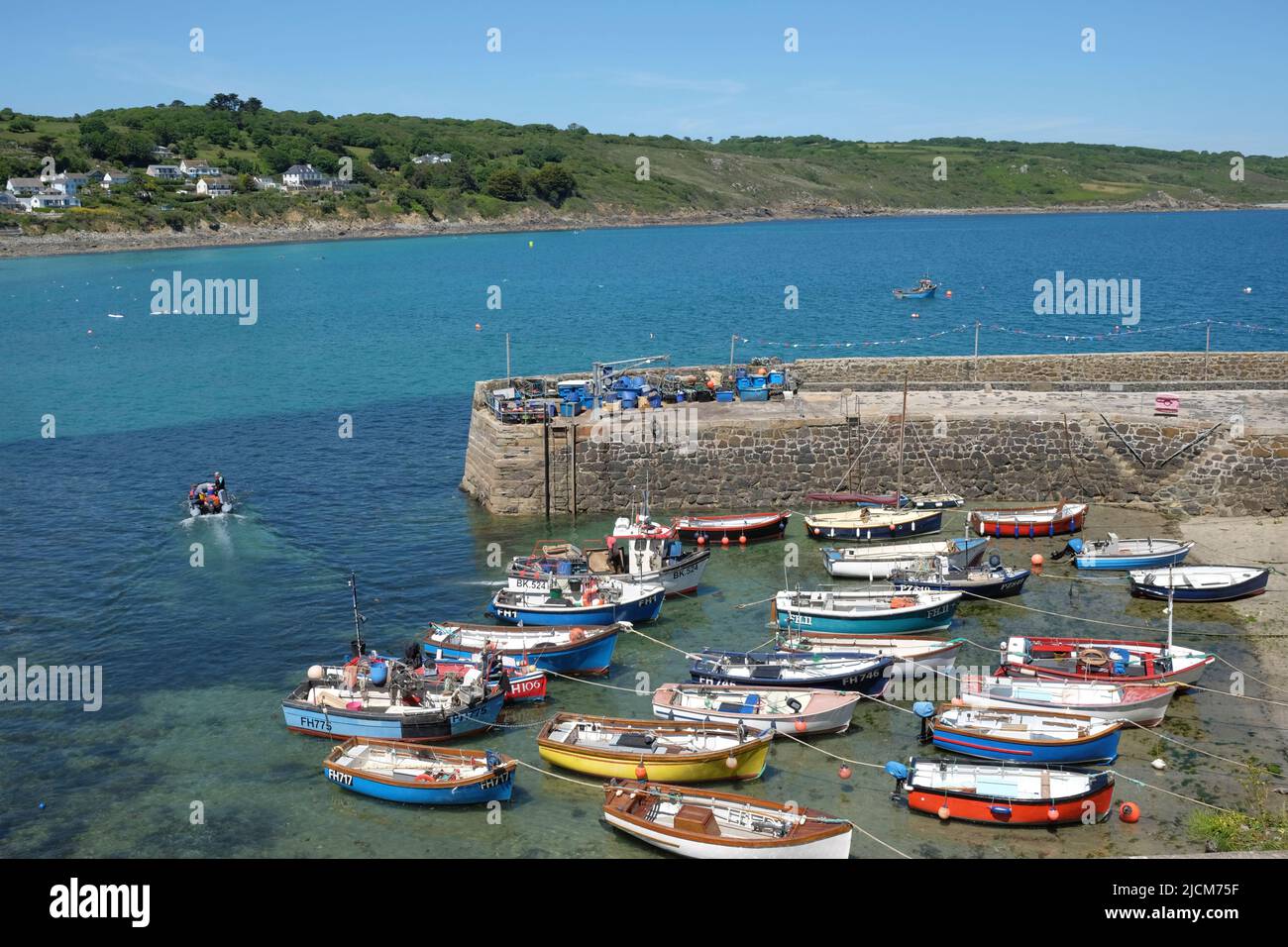 Coverack, Cornwall, UK. 14th June, 2022. No need for an airport queue. Cornwall provides a clear blue sky as the weather forecast predicts warm weather for the next few days. Coverack harbour is quiet before the school holiday rush. Stock Photo