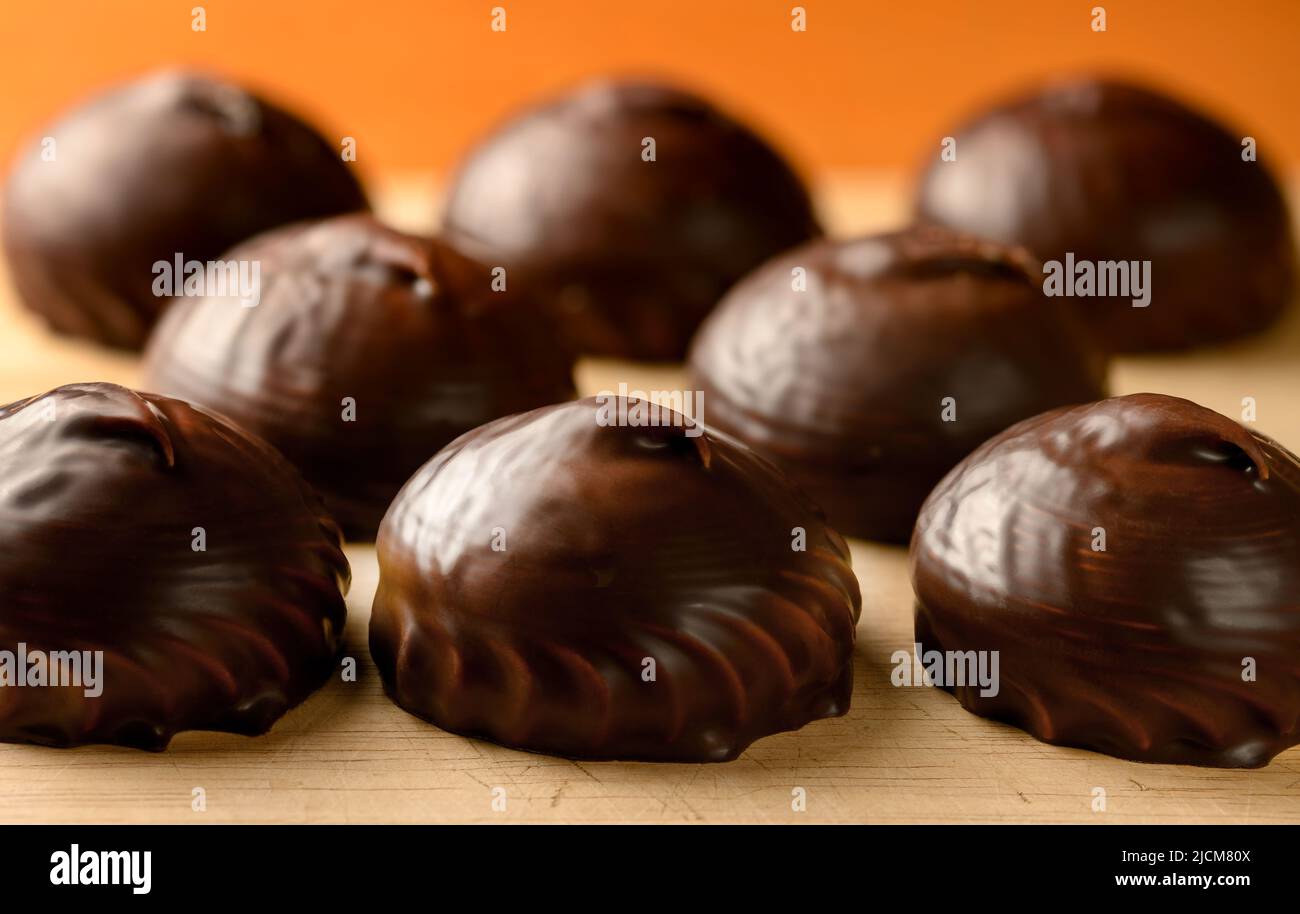Chocolate covered marshmallows on the table front view Stock Photo