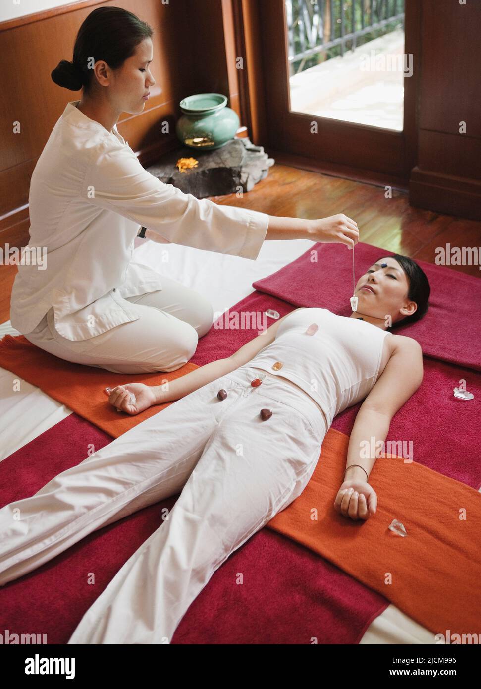 Woman receives crystal therapy at Ananda