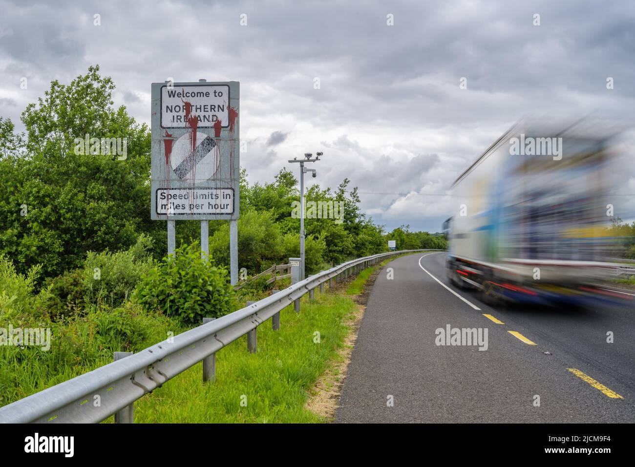 Belfast, UK. 14th June, 2022. A vehicle moves past a border sign near Newry, Northern Ireland, the United Kingdom, on June 14, 2022. The United Kingdom (UK) on Monday introduced a bill to change parts of the Northern Ireland Protocol, a post-Brexit trade deal, while the European Union (EU) said unilateral action is damaging to mutual trust and threatened legal action.TO GO WITH 'Roundup: UK reveals plan to change N. Ireland Protocol as EU threatens legal action ' Credit: Colum Lynch/Xinhua/Alamy Live News Stock Photo