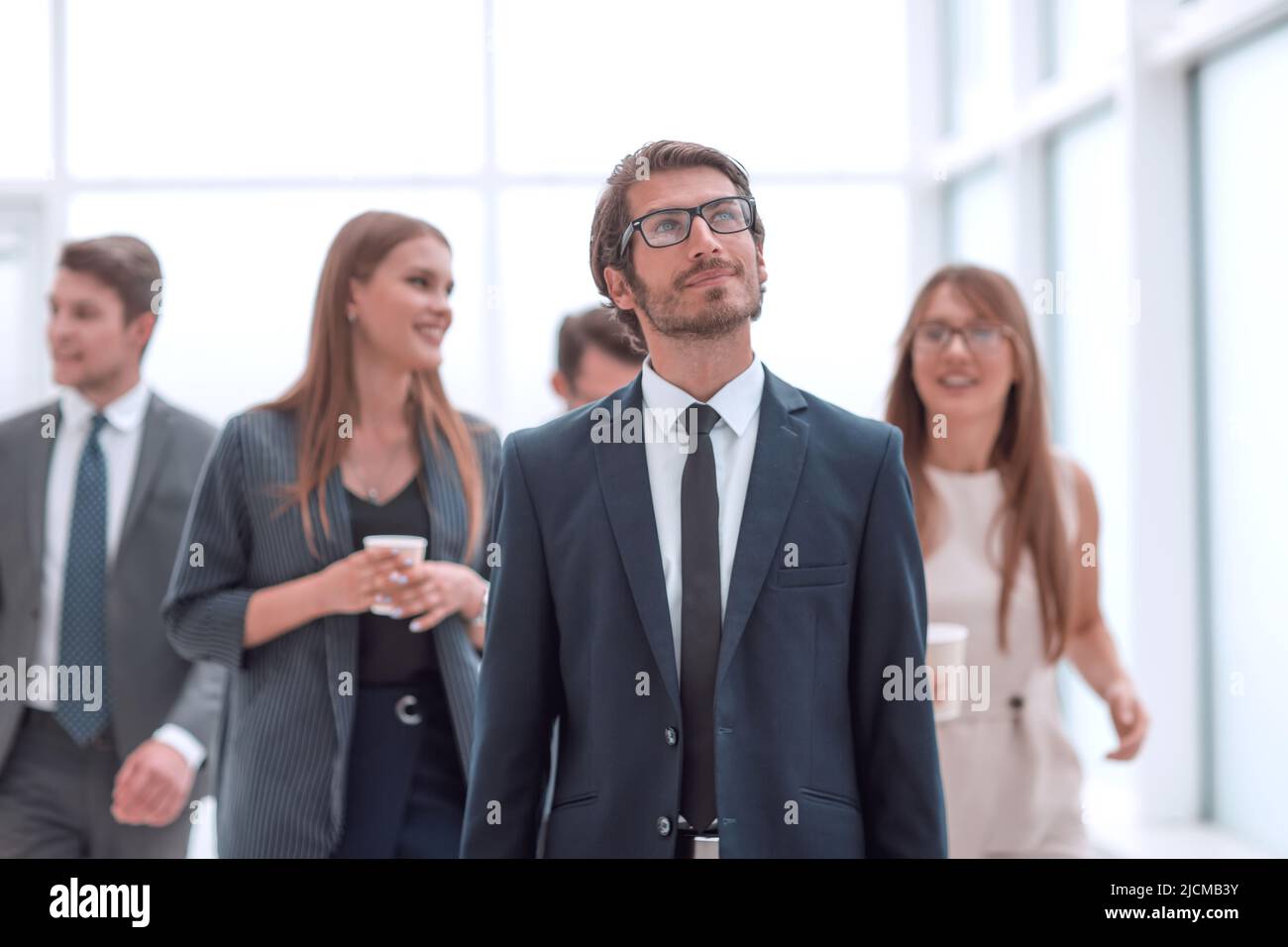 successful young businessman standing in the office Stock Photo - Alamy