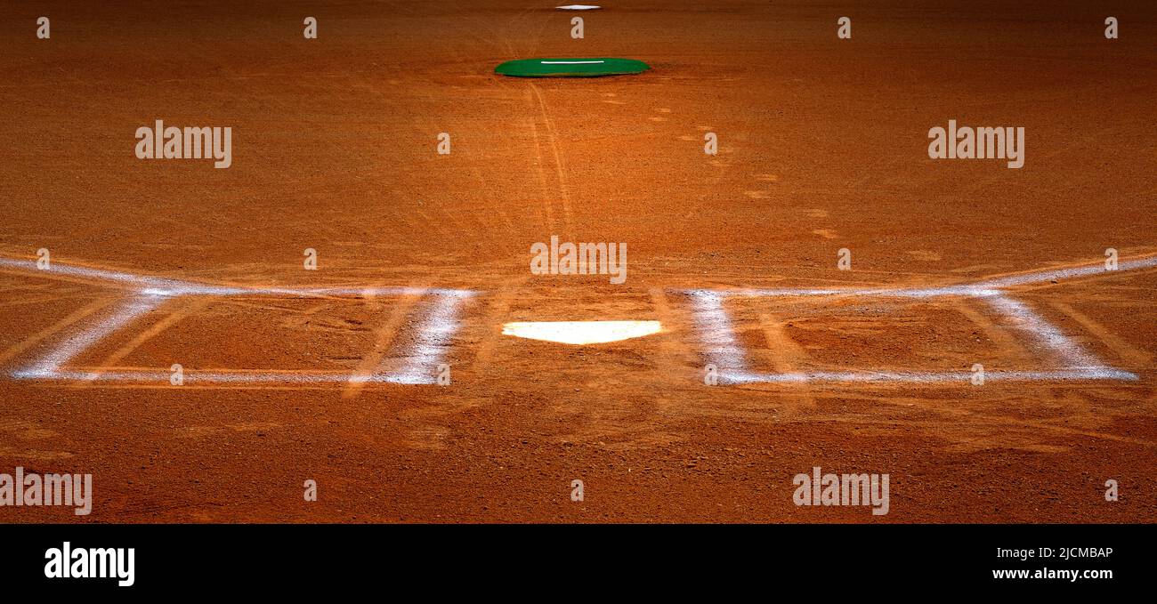 Baseball homeplate with batter box chalk lines in brown clay dirt Stock