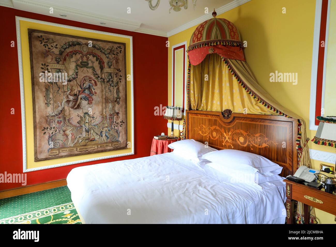 An ornate bedroon inside the Grand Hotel des Iles Borromees, Stresa, Lake Maggiore, Italy Stock Photo